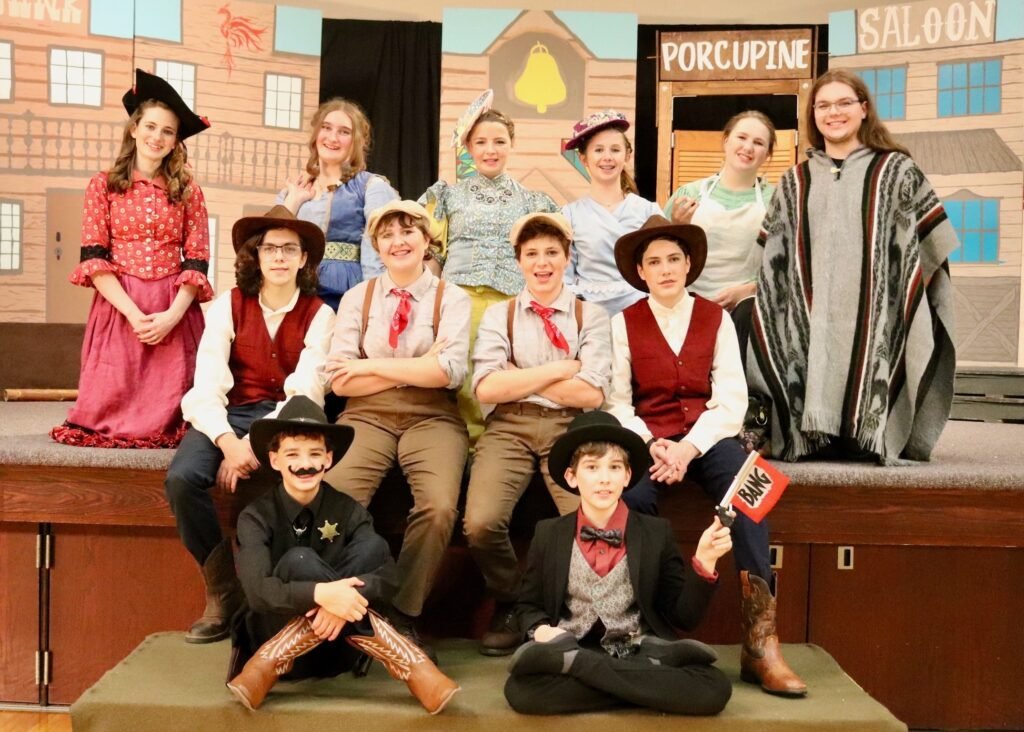 Cast of The Comedy of Errors posing on stage